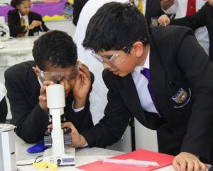science students looking through a microscope