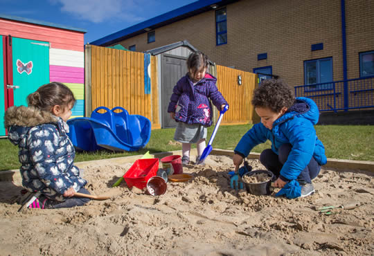 nursery students playing in the sand pit